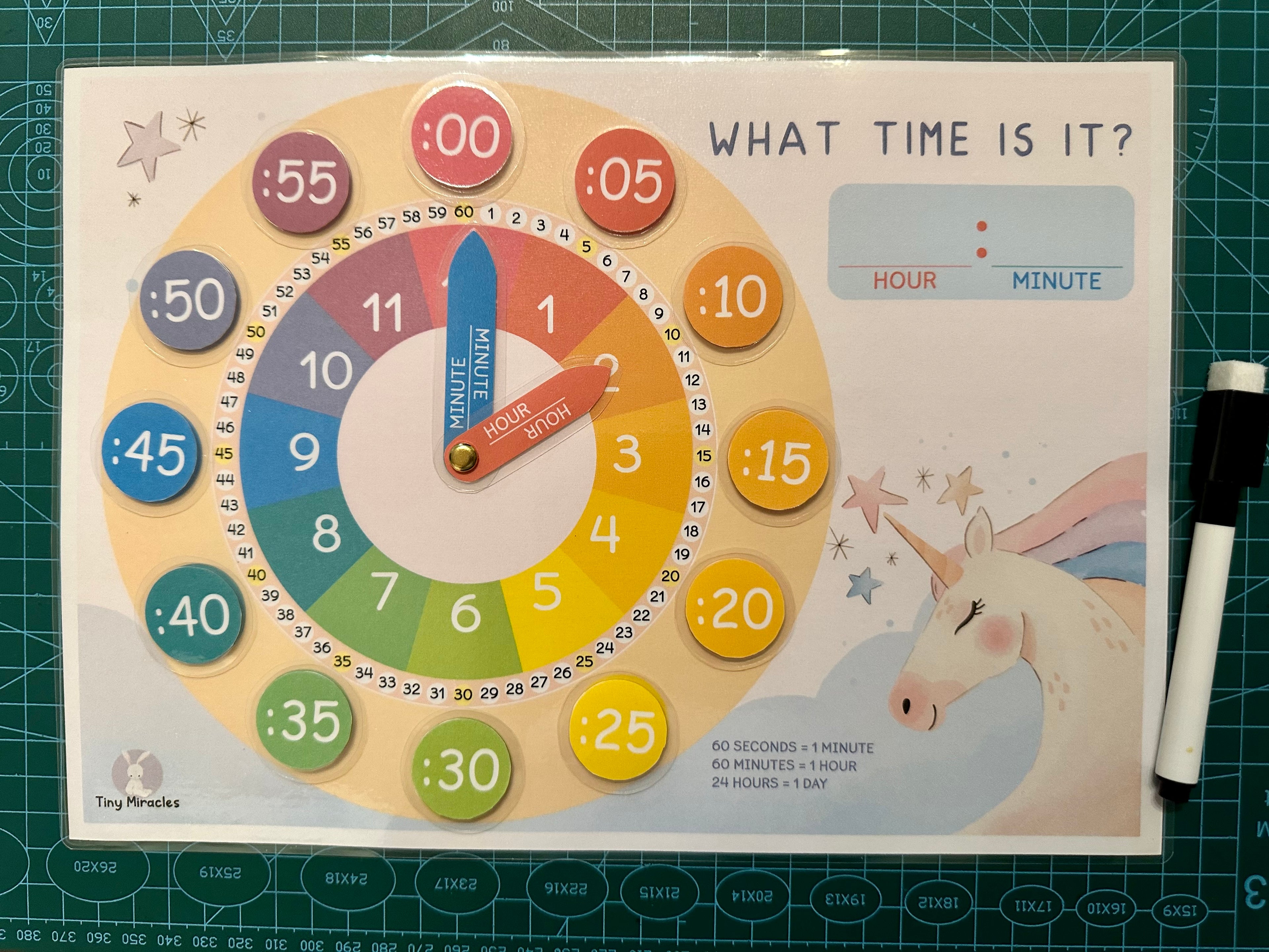 Educational clock toy with colorful numbers and a unicorn illustration