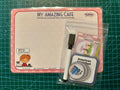 Product set with a whiteboard, pen, and other items on a green cutting mat.