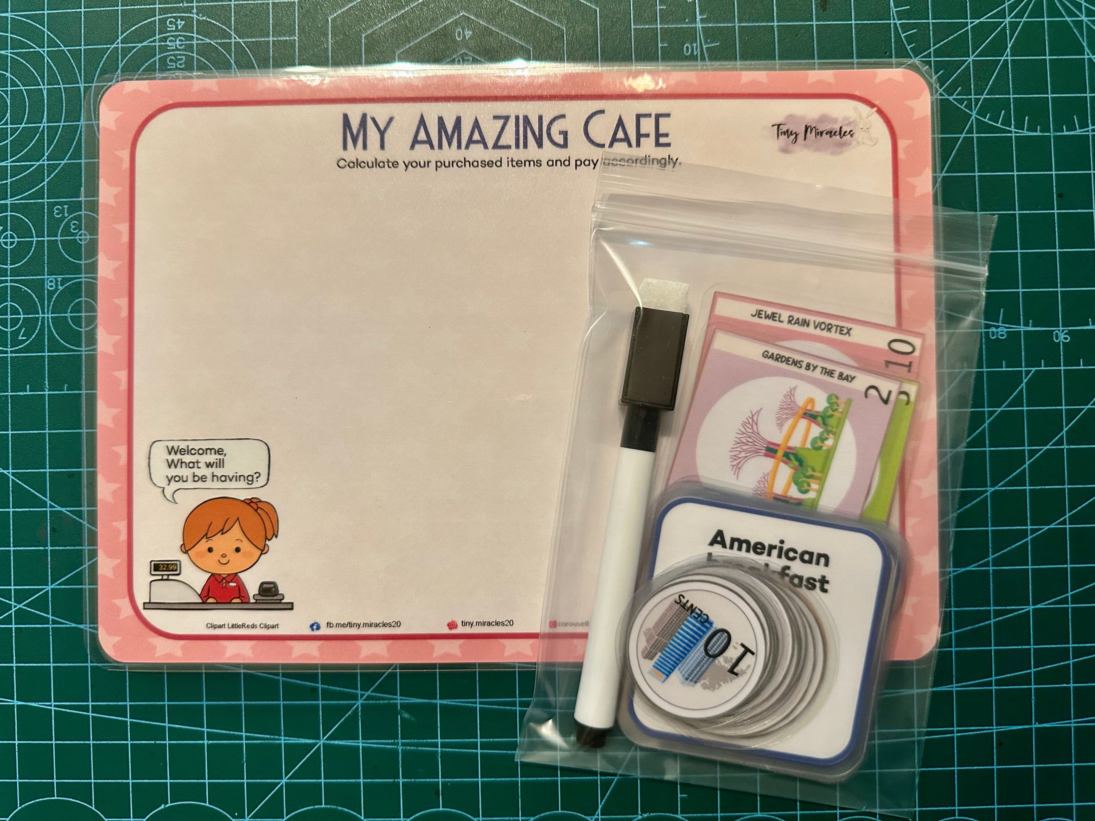 Product set with a whiteboard, pen, and other items on a green cutting mat.