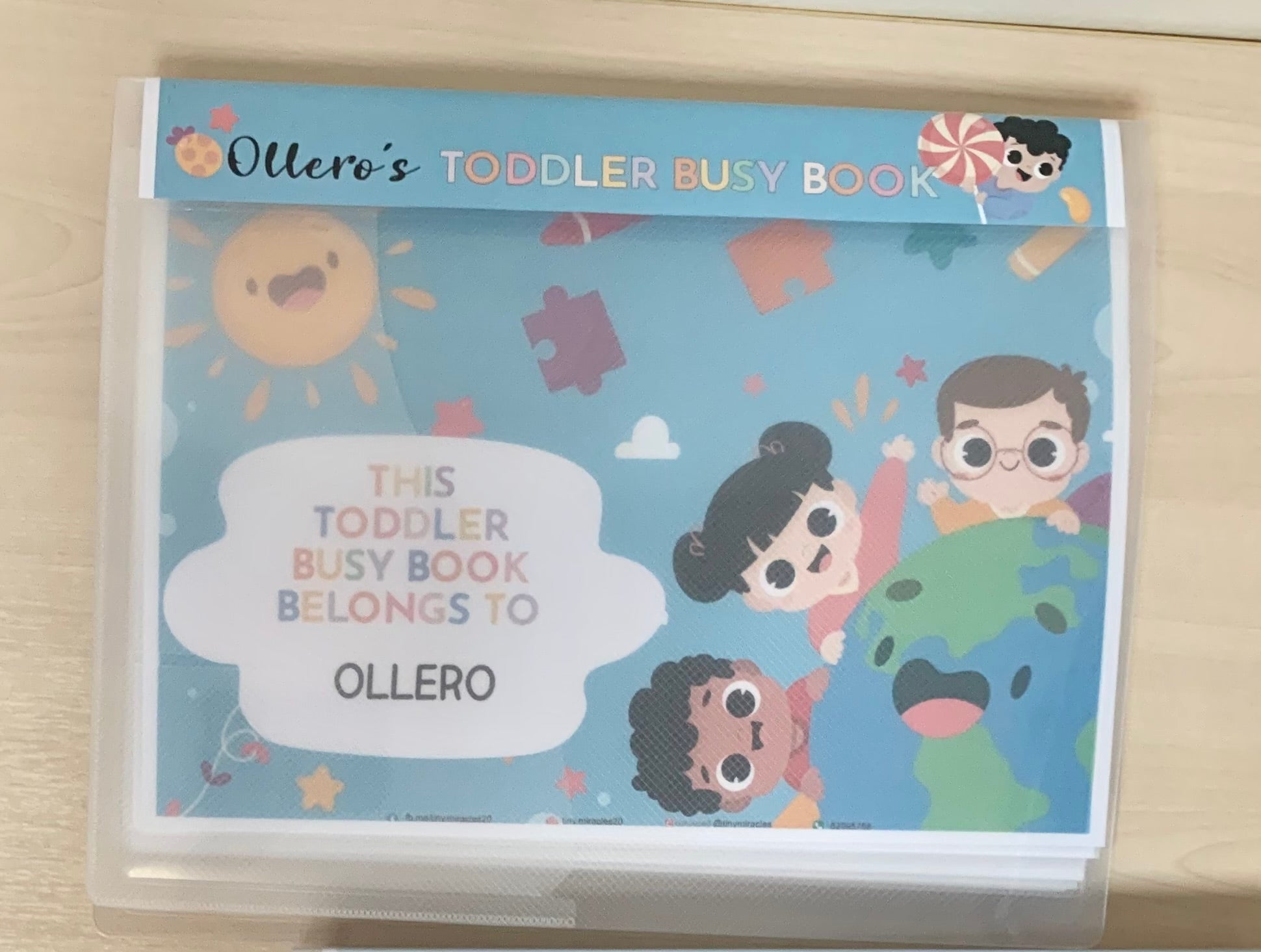 Blue Toddler Busy book with personalised  labeled 'Ollero's Toddler Busy Book