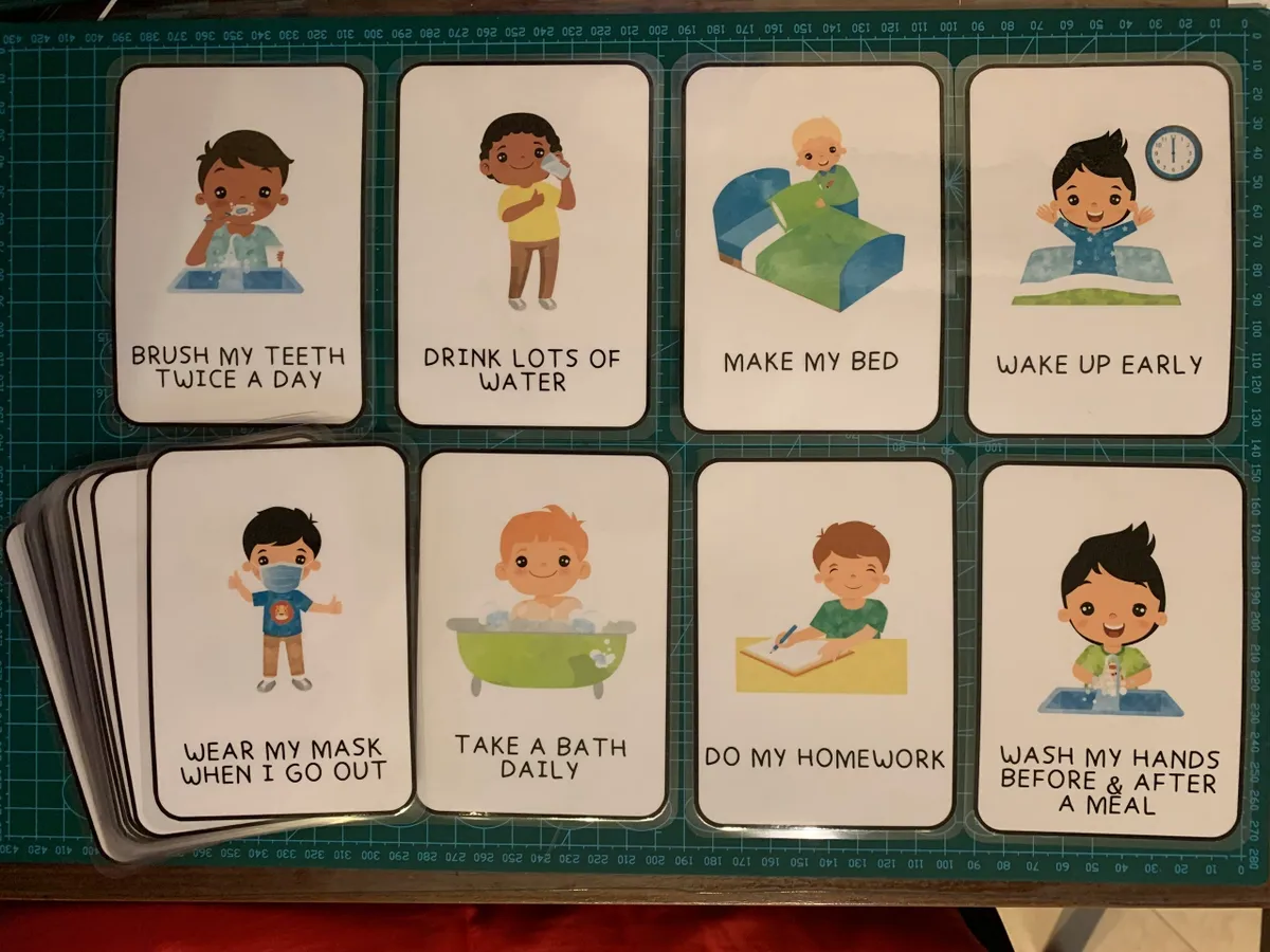 Set of educational cards with illustrations of children performing daily routines on a green grid background.