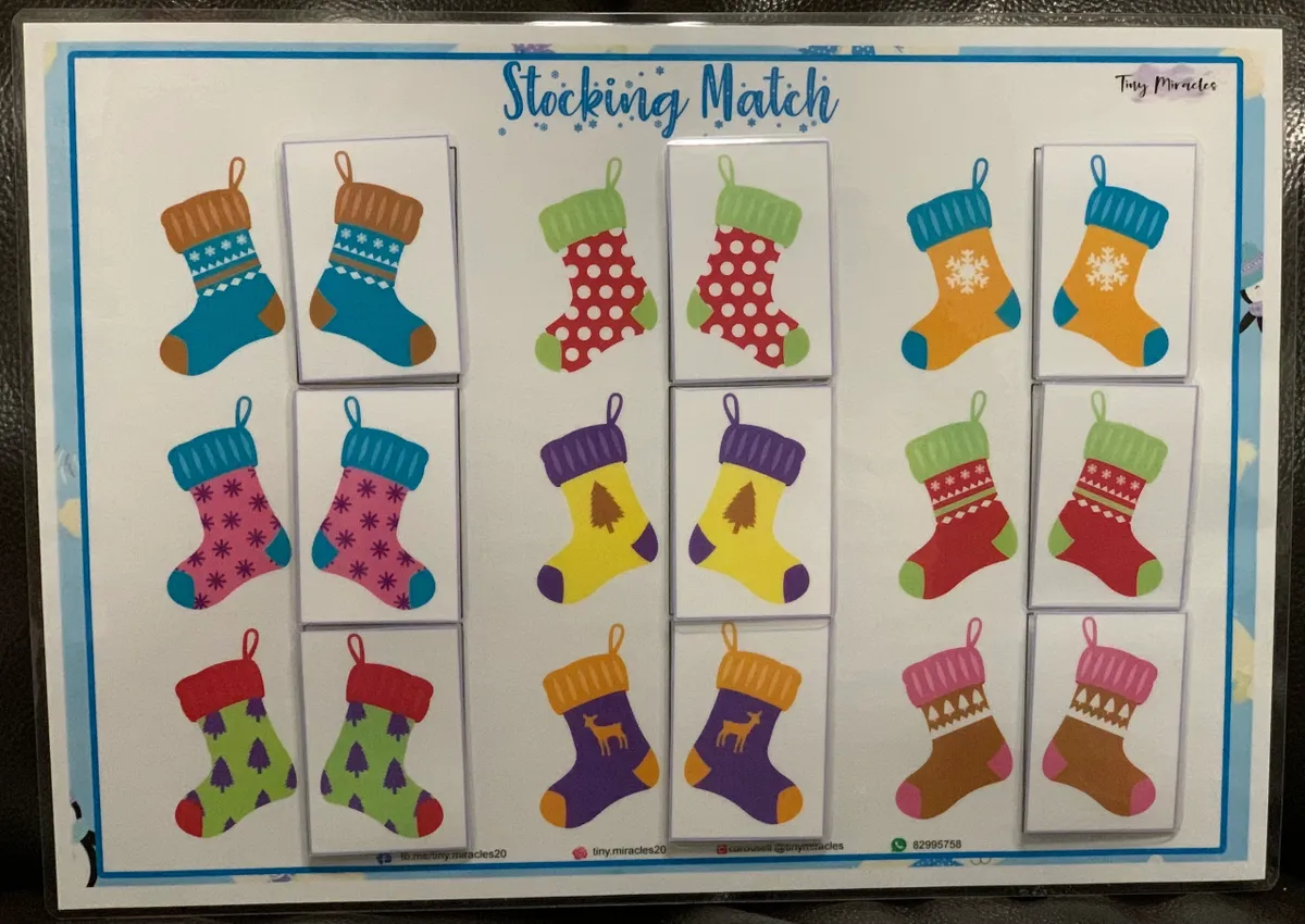 Board game packaging for 'Stocking Match' with colorful Christmas stockings on a white background.