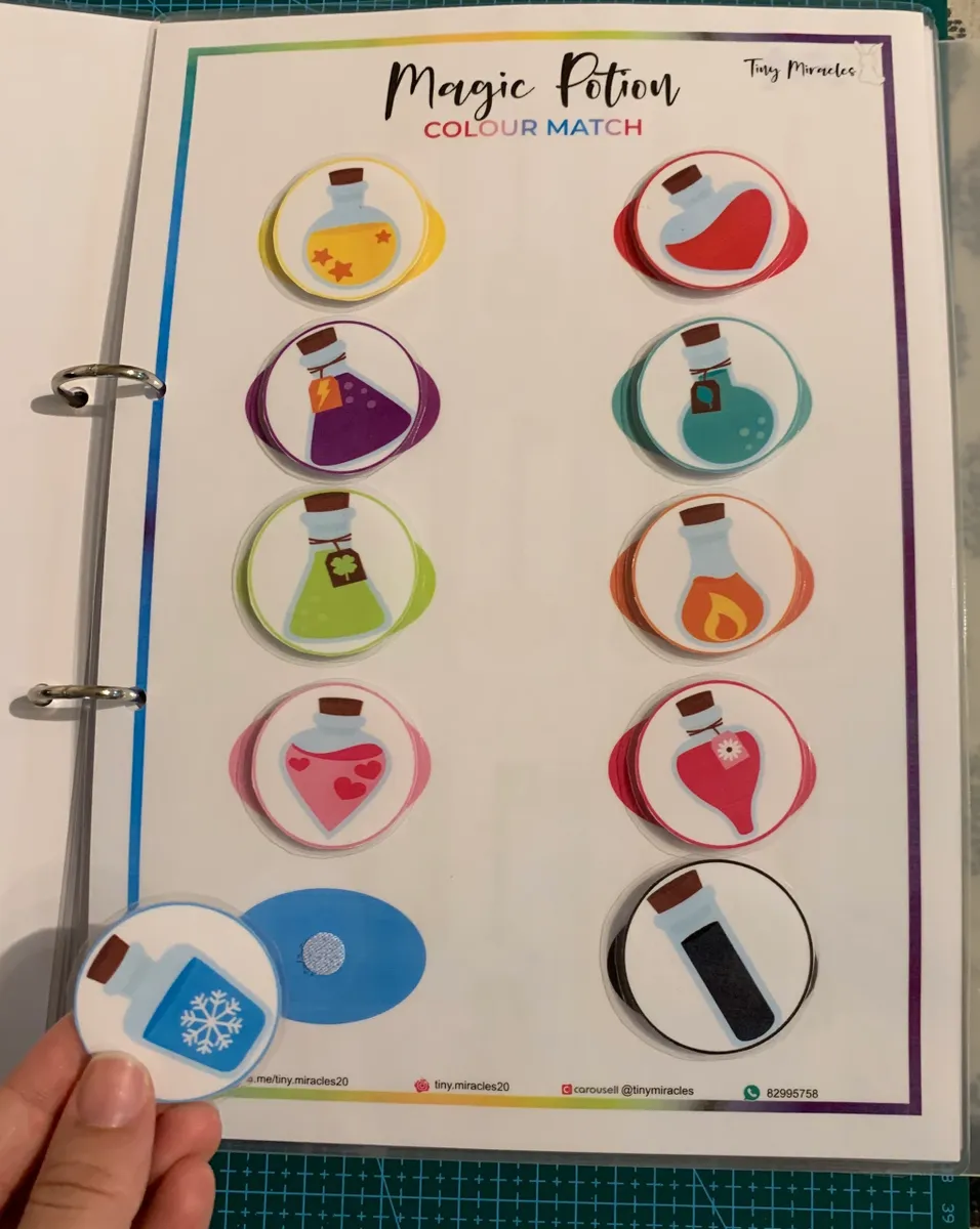 Color matching activity sheet with magic potion stickers held by a hand.